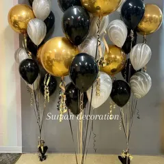 A sophisticated balloon bouquet with a black, gold, and marbled white color scheme. This is great for adult birthdays or corporate events.