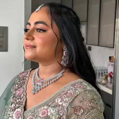 A side profile showing off her half-up hairstyle and glowing skin.