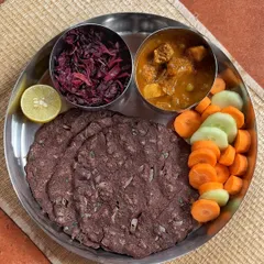 An iron and calcium-rich meal perfect for pregnant and lactating women. This plate features ragi roti, amaranth leaves, and a side of vegetables, providing about 24g of protein and other essential micronutrients.