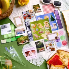 A full view of the Picnic-themed Creative Journaling Kit. It's packed with vibrant stickers, patterned papers, polaroids, and other ephemera to capture the joy of outdoor adventures.