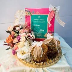 A still shot of the beautiful first card presentation platter. The golden tray, amber-colored jars, and pastel floral arrangement create a look of pure elegance and excitement for the new beginnings.
