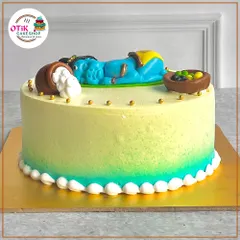 Another view of our adorable sleeping baby Krishna cake, showing the delicate details like the golden beads and the smooth buttercream finish.