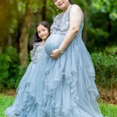 Celebrating with the whole family is so special. I offer matching mother and daughter gowns, like this beautiful grey ruffled set, to create truly memorable portraits that show the bond between a mother, her daughter, and the new baby on the way.