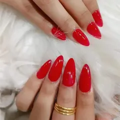 A set of perfectly shaped, glossy red almond nails. A classic look that never goes out of style.