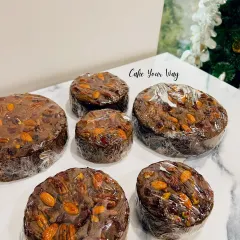 My traditional Christmas plum cakes, wrapped and ready to be shared. They are dense, moist, and packed with soaked fruits and nuts for that classic holiday flavor.