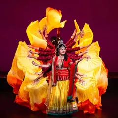 This is a visually stunning moment from one of our productions, using fans to create a multi-armed illusion. This type of creative choreography combines traditional motifs with innovative stagecraft to produce a memorable spectacle.