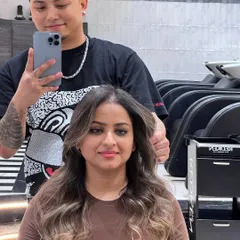 This client's new look was created using Redken 09P and 09V to achieve a cool, ashy tone that beautifully complements her skin. The soft waves and face-framing highlights complete the transformation.