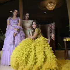 Another view of our exquisite ruffled and frilled gowns. The contrast between the bold yellow and the soft lavender highlights the versatility of our designs, perfect for a colorful mehendi or sangeet.