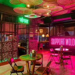 The moody, neon-lit section of Social Offline. The pink and green lights create a cool, modern vibe that's perfect for evening crowds.