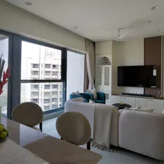 A complete view of the 'Vrindavan' living and dining area. By using a bench for dining and pops of blue, we created a cohesive, open-concept space that feels both spacious and intimate.