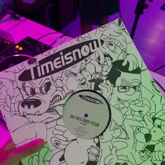 Holding up a 'Time Is Now' vinyl before a set. I'm always digging for new records and dubs to bring to my shows, keeping the selection fresh and exciting.