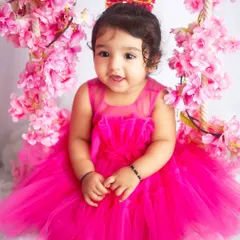 A sweet, happy smile from this little girl, surrounded by pink blossoms. Her joy is absolutely infectious.