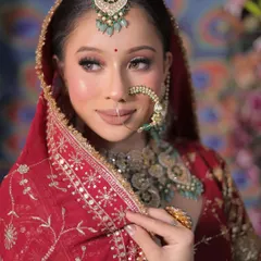 A perfect bridal portrait is all about the details. This close-up shot highlights the flawless makeup, the intricate design of the nath, and the elegant maang tikka, showing our keen eye for capturing every element of the bridal look.
