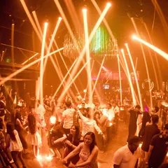 The view of a packed dance floor at Sinq Nightclub in Goa. The laser lights cutting through the haze and a crowd that's fully committed to the dance.