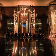 The entrance to a grand wedding reception sets the tone for the entire evening. For this event, we created a mesmerizing archway with flowers and candles, leading guests into a world of enchantment.