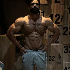 A classic front relaxed pose from one of my athletes. This shot highlights his impressive V-taper, shoulder width, and defined abs.