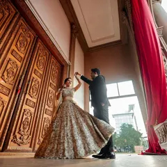 A fairytale moment. The bride's lehenga twirls as they dance, framed by grand architecture. This is the kind of epic, romantic shot we love to create for pre-wedding sessions.