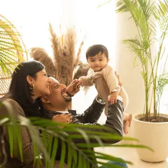 A candid moment of play during a multi-generational family shoot. A father lies back while his child reaches for him, showing the fun and relaxed atmosphere of my studio.