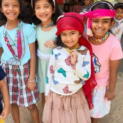Dressing up and making colorful necklaces during our summer camp. These activities encourage self-expression and help develop fine motor skills in a playful environment.