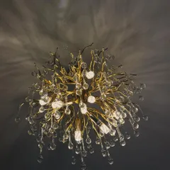 Statement lighting is key to setting the mood in any high-end commercial space. This sculptural chandelier, with its branching metallic form and crystal droplets, acts as a stunning centerpiece in a lobby or dining room, casting intricate shadows and creating an instant sense of luxury.