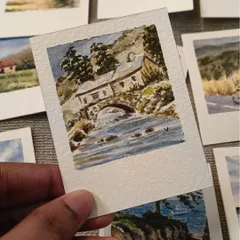A rustic stone bridge over a flowing river, captured in this detailed mini watercolor. I focused on the texture of the old house and the movement of the water to bring this countryside scene to life.