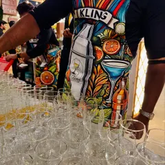 Our team ready for action in their fun, custom-designed aprons. The vibrant artwork reflects our creative and colorful approach to bar service, combining professionalism with a touch of personality.