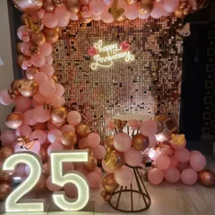 We make milestone anniversaries unforgettable. This 25th-anniversary setup includes a glamorous rose gold sequin wall, a custom "Happy Anniversary" neon sign, and large light-up "25" numbers, creating the perfect backdrop for photos.