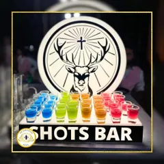 A rainbow of flavors ready to be served. This colorful array of shots isn't just for taste; it's a vibrant part of the decor that promises a fun night ahead.