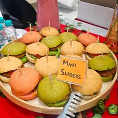 A tray of our mini veg sliders, featuring colorful buns and delicious patties. These are perfect for workshops and parties where guests want a quick, satisfying bite.