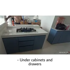 This image shows the under-counter cabinets and drawers of the blue kitchen. The handleless design contributes to its minimalist and modern appeal.