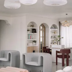 Another view of the Eden House living and dining space, showing the open, airy feel and the seamless connection between different zones. The arched doorways are a recurring motif throughout the home.