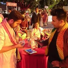 Here I am performing at a social gathering, using a small table as my stage. With an iPad and a deck of cards, I can create a hub of entertainment, drawing guests in with interactive tricks that they can see from all angles.