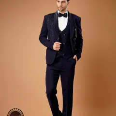 For a reception or cocktail evening, nothing compares to a perfectly tailored tuxedo. This deep navy three-piece suit features an embellished lapel, blending classic western tailoring with a touch of Indian grandeur.