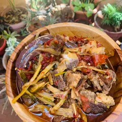 A comforting bowl of beef bones cooked in a hearty broth with bamboo shoot stem, dried cauliflower stem, and brinjal.