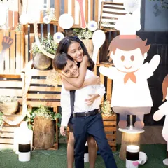 Even in the middle of a lively party, we can find a moment for a lovely sibling portrait. This photo captures the sweet and playful bond between a brother and sister against the backdrop of their fun party theme.