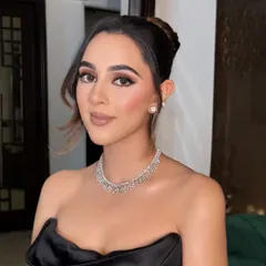 A closer look at the makeup, showing the clean lines of the eyeliner and the subtle contouring that defines her features beautifully.