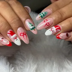 Get into the holiday spirit with this festive Christmas nail art, featuring hand-painted Santa hats, trees, and bows.