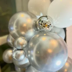 We added mini disco balls to the balloon arrangements for that extra bit of sparkle and fun, perfectly fitting the party theme.
