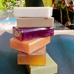A beautiful stack of my handmade soaps, including Red Wine, Papaya, Neem, and Shea Butter. I use an organic certified soap base and natural extracts to create these bars, ensuring they are gentle and nourishing.
