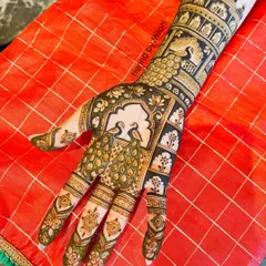 A classic Rajasthani-inspired bridal design. This henna art showcases majestic peacocks within ornate jharokha frames, a timeless choice for brides who love traditional Indian motifs.
