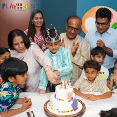 A beautiful family moment as Ali cuts his art-themed birthday cake, surrounded by his loved ones.