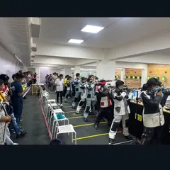 A wide view of the bustling range during the CISCE School Nationals. The gallery is filled with coaches and spectators, creating a high-pressure environment for our young athletes.
