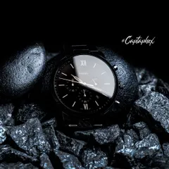 A wider composition from the Fossil watch concept shoot, showing the full watch in its environment. This shot establishes the overall mood and provides context, showcasing how the product interacts with the textured elements. It's a powerful image for lifestyle branding and advertising.
