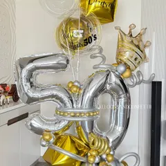 Celebrating a half-century in style! This grand 50th birthday balloon bouquet in silver and gold, complete with a crown, is designed to be a magnificent centerpiece for a milestone celebration.