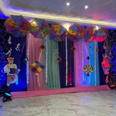 The Lohri stage under blue lighting, which adds a cool contrast to the warm, colorful decor.