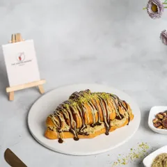 Meet our famous Croissant Prashant. We took a flaky, buttery croissant, stuffed it with sweet and crispy kunafa, and drizzled it with chocolate. It's the unique flavor and texture combination that started a craze.