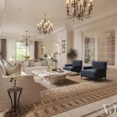 A wider view of the same elegant living room, highlighting the symmetrical layout and the grand scale. The dual chandeliers and expansive windows create a bright and airy atmosphere, while the classic rug anchors the sophisticated seating arrangement.