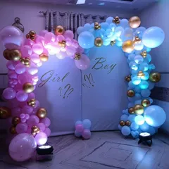 Building suspense for a gender reveal party with a "Girl or Boy?" theme. This backdrop uses distinct pink and blue balloon arches with spotlights to create a dramatic and exciting reveal moment.