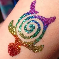 Look at the detail and color in this rainbow turtle glitter tattoo. I use multiple shades of cosmetic-grade glitter to make each design pop, ensuring it’s a standout piece of temporary body art.