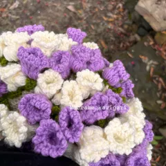 A close-up of the crochet flowers that form the edge of our baby blanket bouquet. We use soft purple and white cotton yarn to create this delicate floral border.
